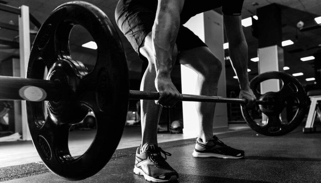 Closeup of weightlift workout at the gym with barbell.